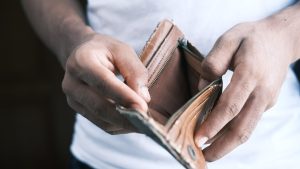 Photo of man holding empty wallet