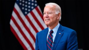 President Joe Biden standing in front of an American flag