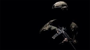 Silhouetted soldier against a black background