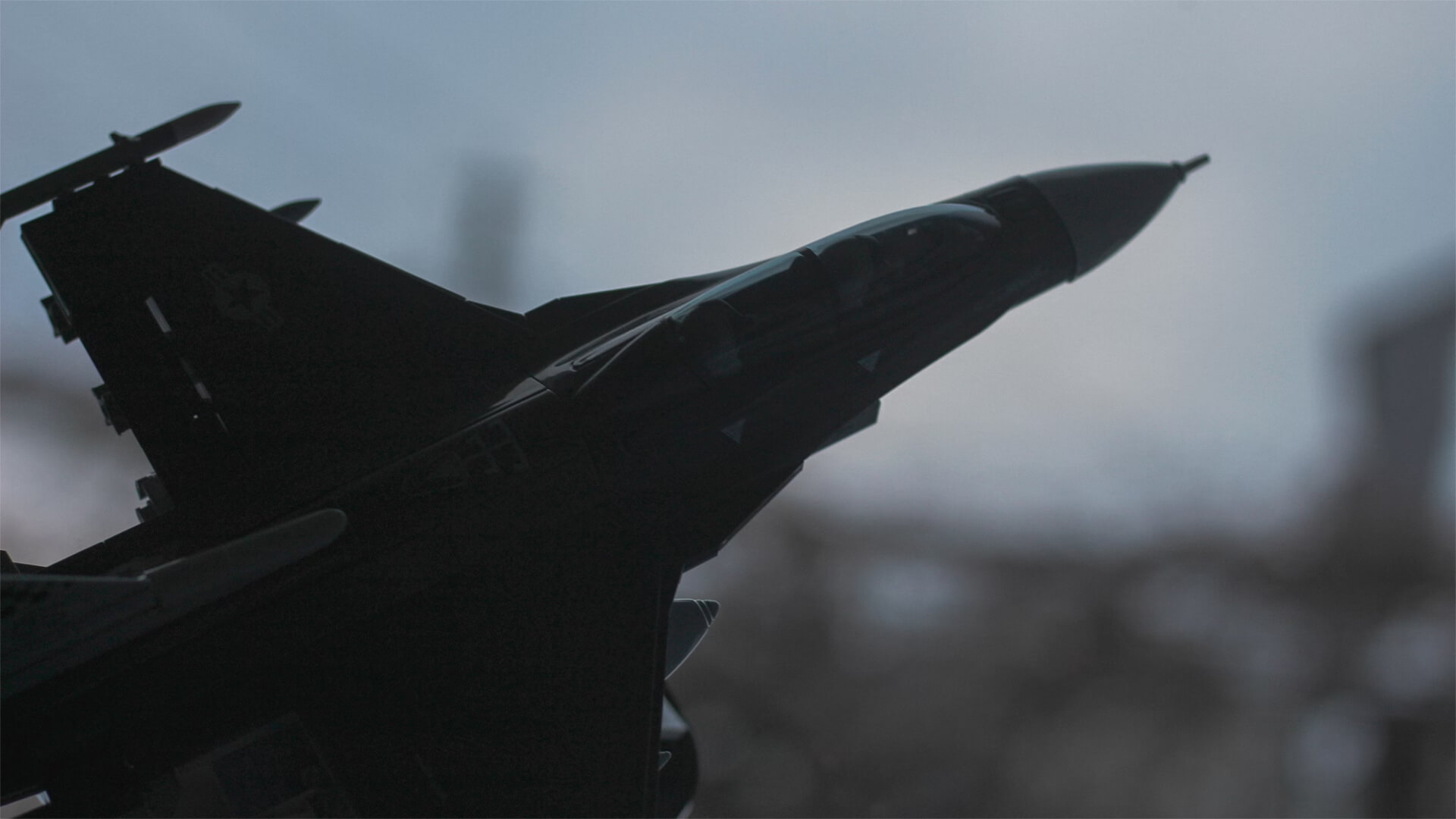 A fighter jet flying through a cloudy sky