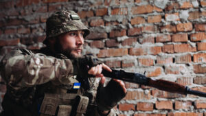 A Ukrainian soldier advances with an AK 47