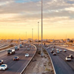 A photo of Saudi Arabian traffic against a desert skyline