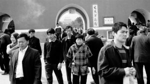 Photo of Chinese men and women in a town square