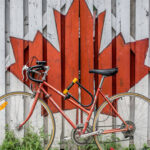 Photo of a bicycle in front of the Canadian flag