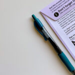 Picture of a pen next to a voter ballot