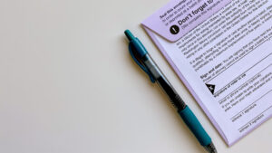 Picture of a pen next to a voter ballot