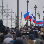 Crowd of people carrying Russian flags