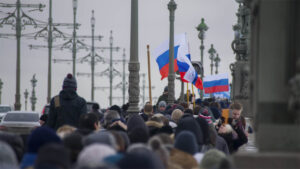 Crowd of people carrying Russian flags