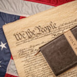 Photo of a bible on the US constitution and flag