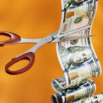 Photo of $100 bill being cut