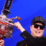Musk swings the "Chainsaw for Bureaucracy" at CPAC 2025. From wikimedia commons: https://en.wikipedia.org/wiki/Department_of_Government_Efficiency#/media/File:Elon_Musk_(54349592271).jpg