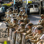 Photo of soldiers at the California 2025 ICE protests. Image by Wikimedia commons: https://upload.wikimedia.org/wikipedia/commons/f/f4/Los_Angeles_riots_-_June_2025_-_20250613.jpg