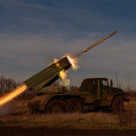 Military vehicle shooting artillery