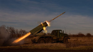 Military vehicle shooting artillery