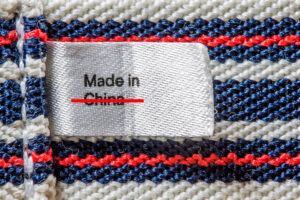 A made in China tag crossed out. Photo by Envato Elements and licensed