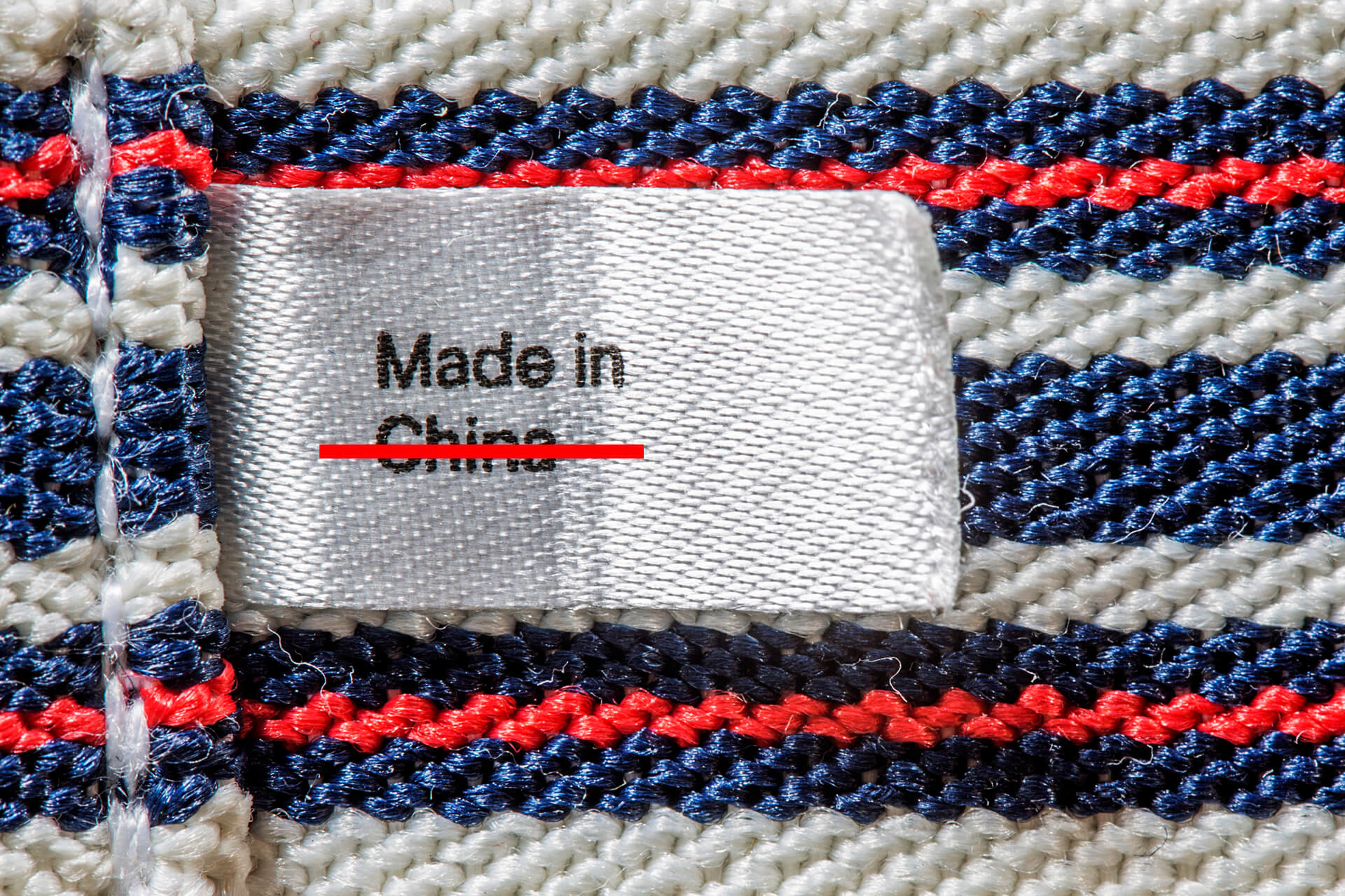 A made in China tag crossed out. Photo by Envato Elements and licensed