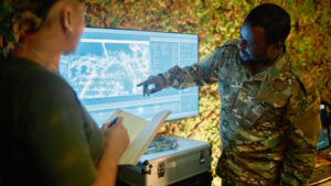 Photo of a soldier pointing to a tech screen