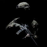 A silhouetted soldier in a black background