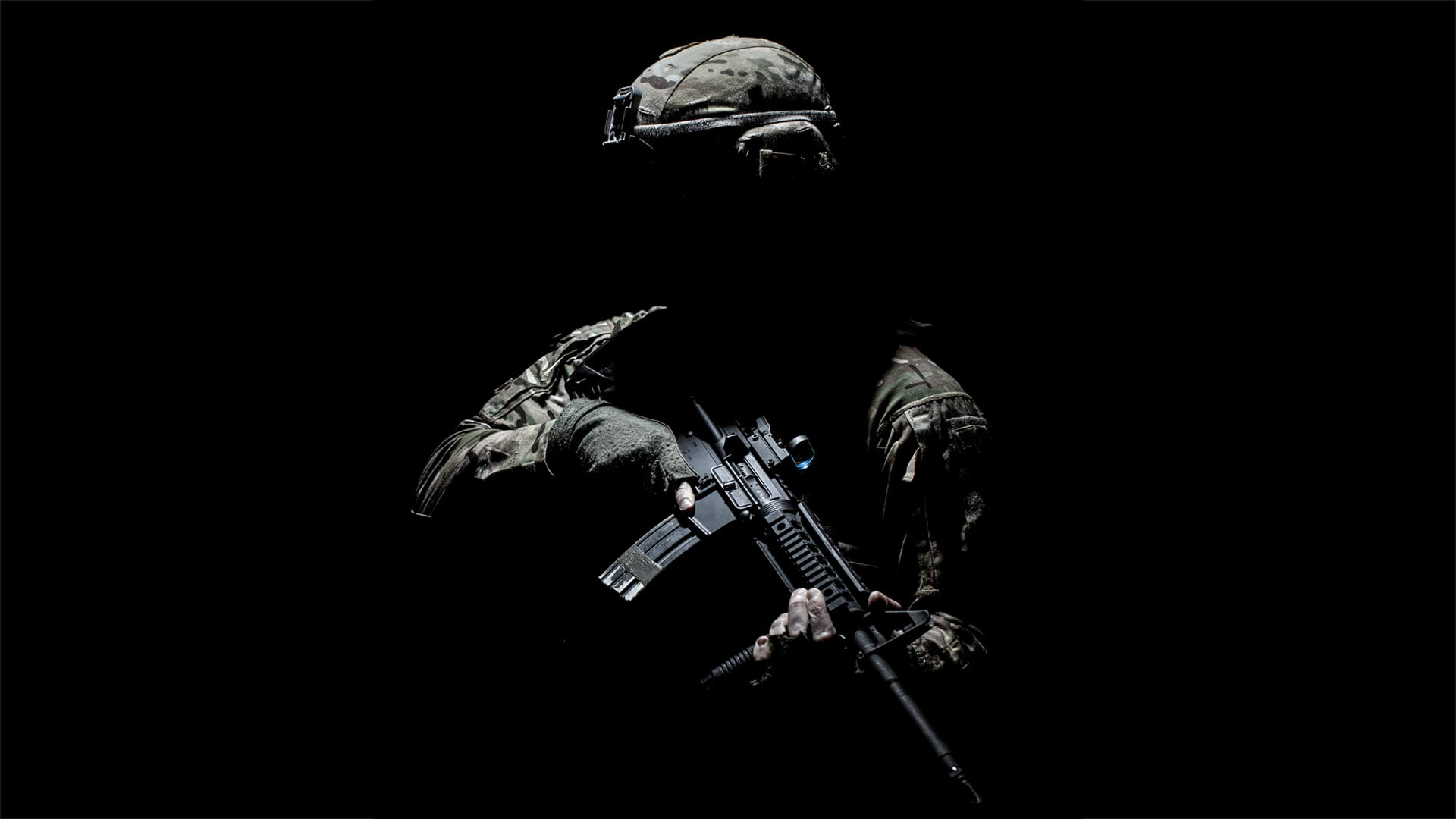 A silhouetted soldier in a black background