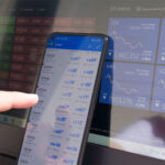 Person using Forex trading on a laptop and phone