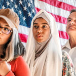 Immigrants standing in line in front of an American flag | Licensed by Envato Elements
