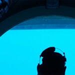 Midshipman looking out the cockpit of a submarine