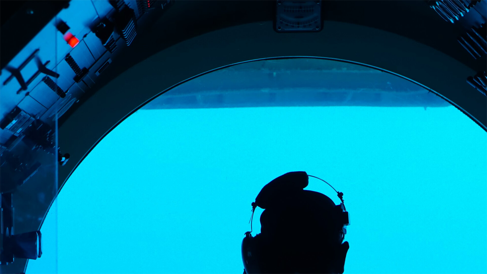 Midshipman looking out the cockpit of a submarine