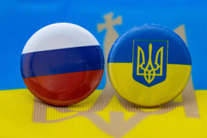 A Russia and Ukraine button on top of a Ukraine flag