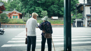 A Japanese elderly couple at a crosswalk