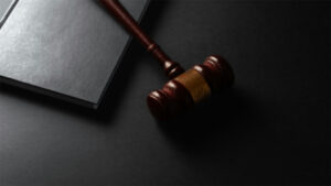 A gavel and law book on a desk