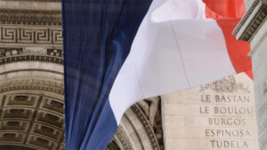 A french flag over the Arc de Triumph