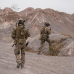 Squad of Soldiers Running Forward and Atacking Enemy During Military Operation in the Desert | Licensed by Envato Elements: https://app.envato.com/search/photos/b369387a-4bc2-43d2-808a-0341aa11dbcc?itemType=photos&term=military+desert&sort=relevance