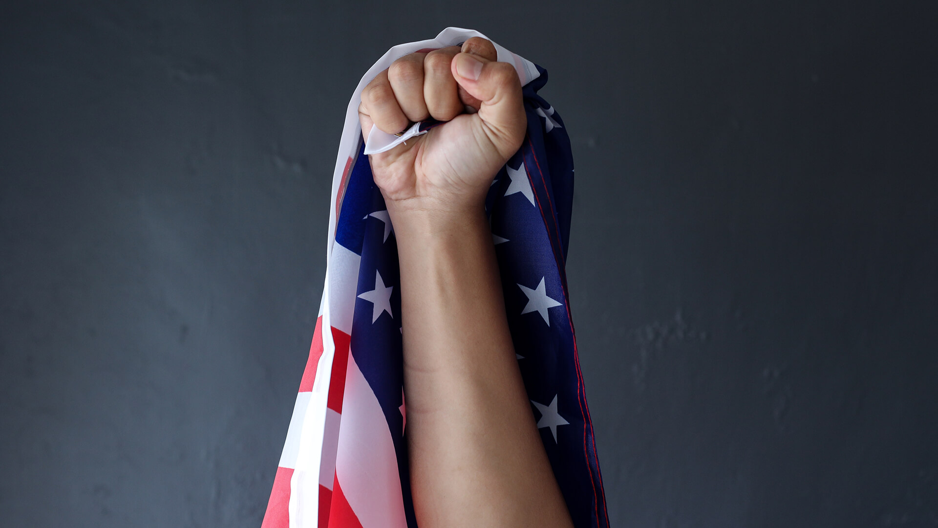 Fist raised with an American flag in it | Licensed by Envato Elements: https://app.envato.com/search/photos/939fd782-14f6-41bc-a6c2-37f108609543?itemType=photos&term=american+power&sort=relevance