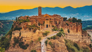 Photo of the city of Civita di Bagnoregio, Italy with mountains in the background