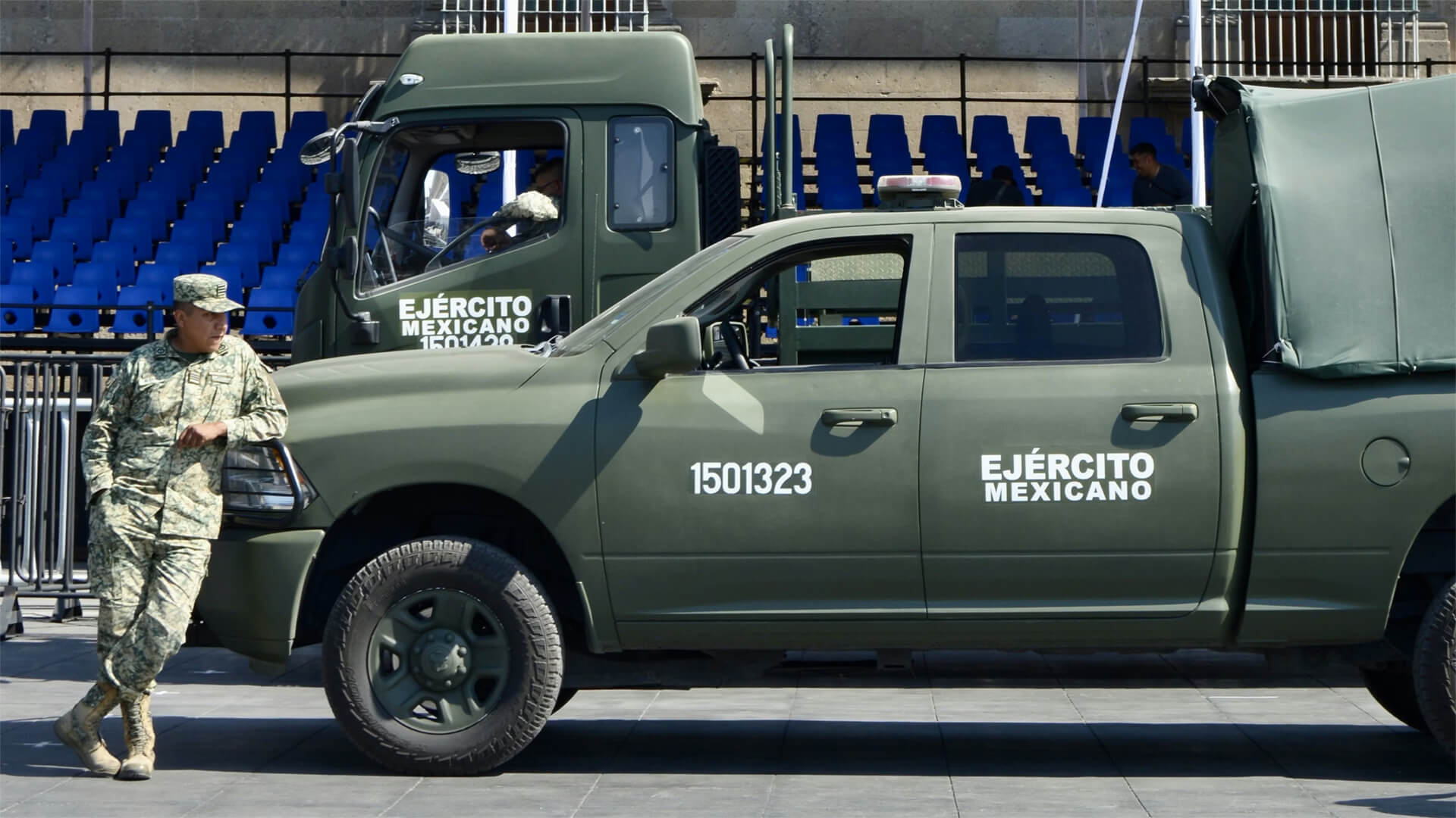 A Mexican solider leans against a military truck