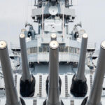Navy warship with guns facing forward