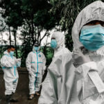 Doctors in biohazard suits
