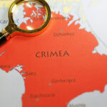 A magnifying glass on a map of Crimea | Licensed by Envato Elements