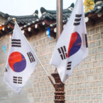 Two Korean flags in front of a building