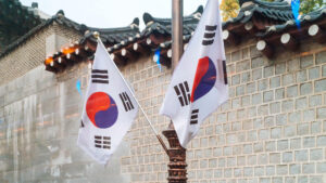Two Korean flags in front of a building