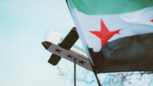 Syrian flag waving with a syrian box airplane in the background