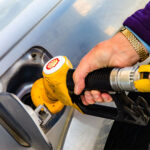 Hand shown pumping diesel fuel with a Shell logo on nozzle