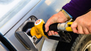 Hand shown pumping diesel fuel with a Shell logo on nozzle