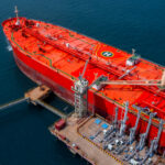 Large Red Tanker Ship Docks at an Oil Terminal