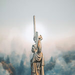 Statue in Kiev, Ukraine against a misty forest