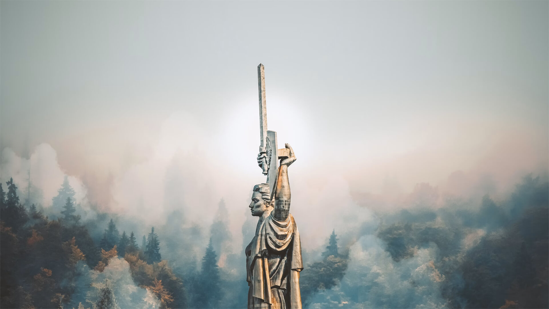 Statue in Kiev, Ukraine against a misty forest