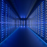 Blue lit hallway of data center servers producing energy